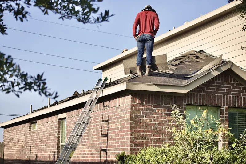 Professional roofer working on a residential roof in Croix Estates